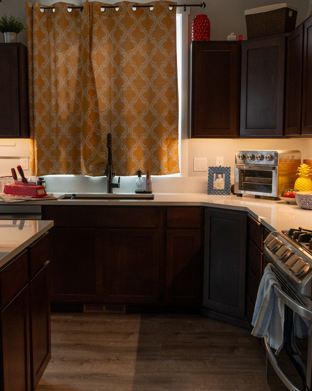 Under-cabinet LED task lighting across a kitchen sink and preparation counter